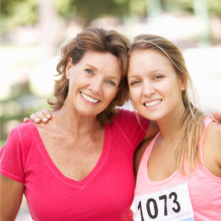 two females in pink t-shirts participating in a charity event fun run
